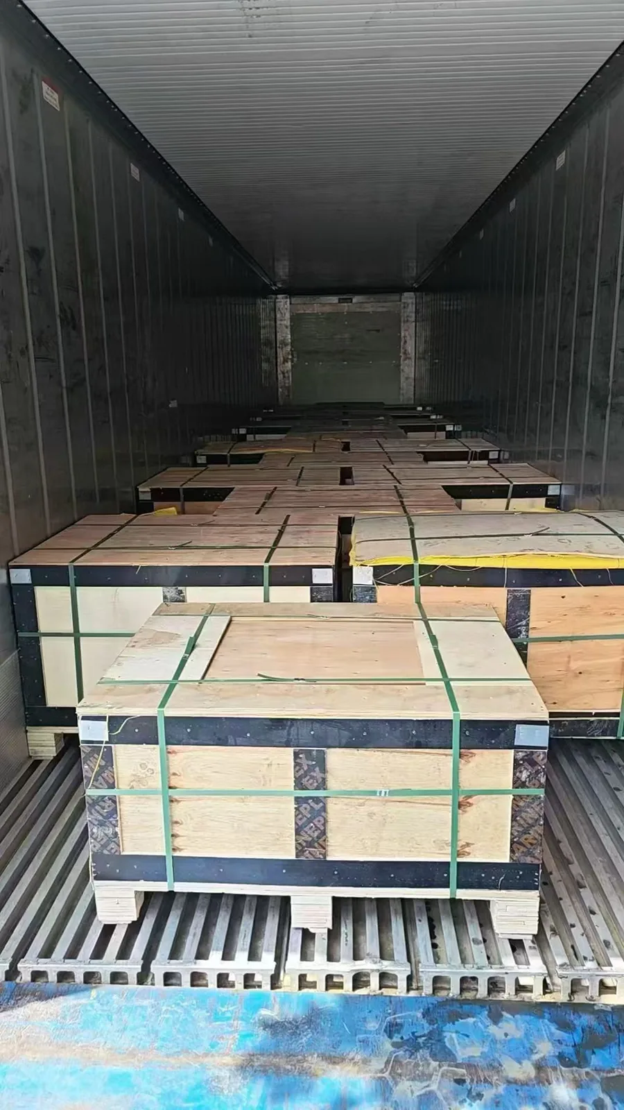 Export crates of hot-dip galvanized fasteners positioned inside a shipping container